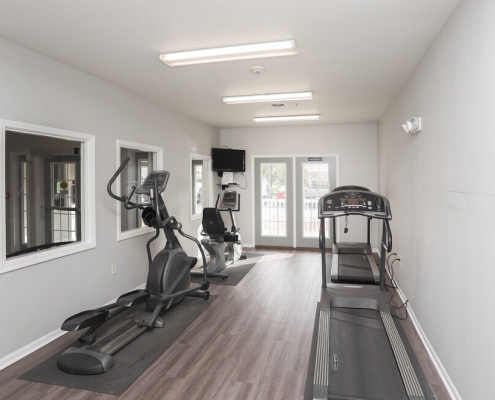 room with two treadmills, an elliptical, and stationary bike
