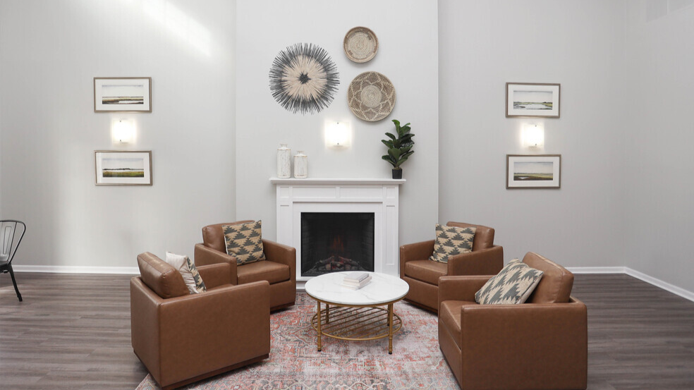 community room with fireplace, chairs, and a coffee table at brookhaven senior apartments